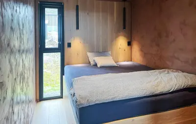 a bedroom with a bed in a room with a window at Amazing Home In Løten in Løten