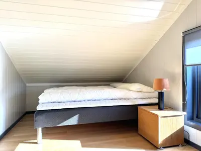 a bed in a room with a roof at Modern mountain cabin in Tisleidalen, Golsfjellet in Gol