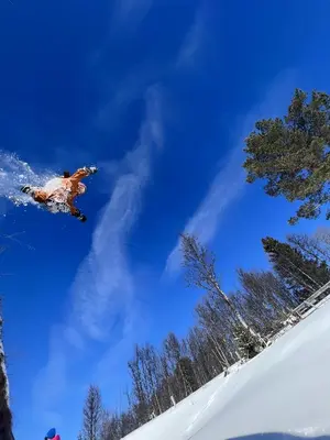 a man flying through the air while riding a snowboard at Modern mountain cabin in Tisleidalen, Golsfjellet in Gol