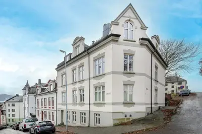 a white building with a tower on top of it at Apartment in the Heart of Ålesund in Ålesund