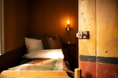 a room with a bed in a room with a door at Per Amundsagården in Røros