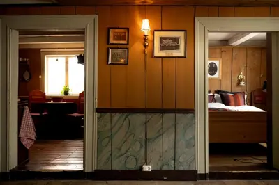 a room with a bed and a glass door at Per Amundsagården in Røros