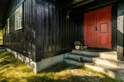 a red door on the side of a house at Mountain Cabin With Cross-Country Trails In Rauland in Rauland