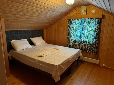 a large bed in a room with a window at A comfy House in Hol