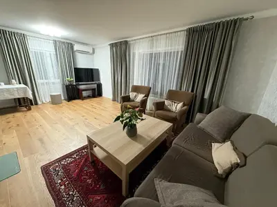 a living room with a couch and a table at A comfy House in Hol