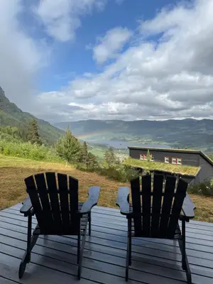 two chairs on a deck with mountains in the background at Apartment with a view at Bavallen Tråstølen Voss in Vossevangen