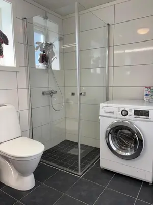 a bathroom with a toilet and a washing machine at Modern apartment in Voss in Vossevangen