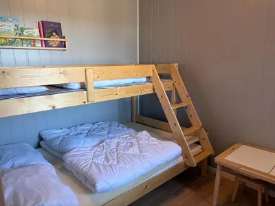 two bunk beds in a room with a ladder at Modern apartment in Voss in Vossevangen