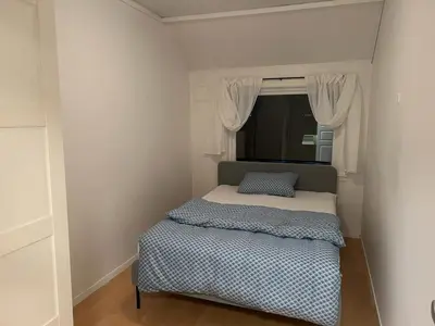 a small bedroom with a bed and a window at Spacious 3 Bedroom Townhouse in Bergen