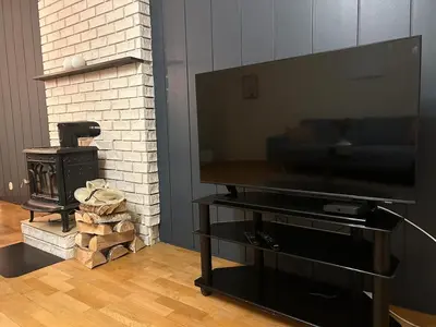 a living room with a flat screen tv and a fireplace at Spacious 3 Bedroom Townhouse in Bergen