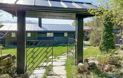 a gate to a house with a solar roof at Knausen in Ørsta