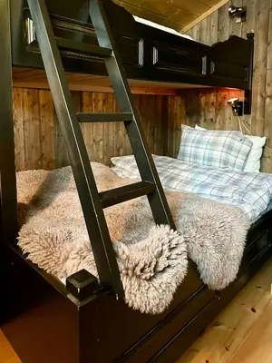 a bunk bed with two furry pillows on it at Family-Friendly Mountain Cabin At Haglebu in Haglebu