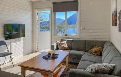 a living room with a couch and a table at 2 Bedroom Lovely Home In Ørsta in Ørsta