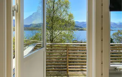 a room with a window with a view of a lake at Awesome Home In Ørsta in Ørsta