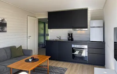 a living room with a couch and a kitchen at Awesome Home In Ørsta in Ørsta