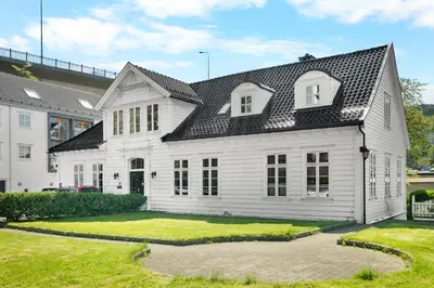 a white house with a black roof at Historic Bergen Home I Free Parking in Bergen