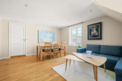 a living room with a blue couch and a table at Historic Bergen Home I Free Parking in Bergen