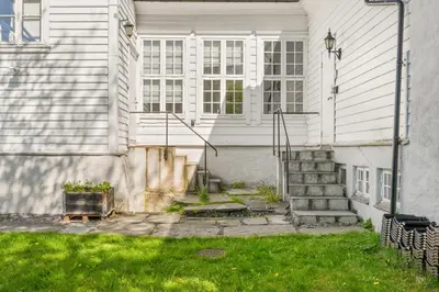 a white house with stairs and a window at Historic Bergen Home I Free Parking in Bergen