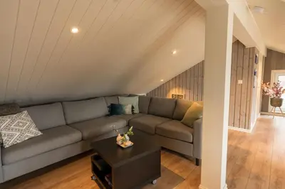a living room with a couch and a table at Mountain View Lodge in Stranda