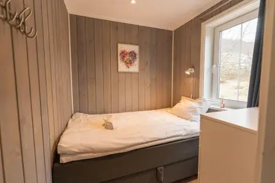 a small bed in a room with a window at Mountain View Lodge in Stranda