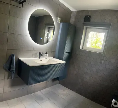a bathroom with a sink and a mirror at Husslåttene apartments 2 in Skei