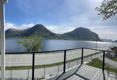 a view of a body of water with mountains at Husslåttene apartments 2 in Skei