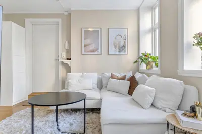 a living room with a white couch and a table at Central Charm in Bergen