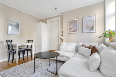 a living room with a white couch and a table at Central Charm in Bergen