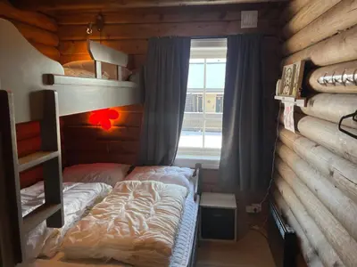 a bedroom with two bunk beds and a window at Log Cabin With Mountain View in Beitostøl