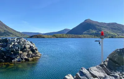 a red fire hydrant on the side of a lake at Amazing Home In Ørsta With Wifi in Ørsta