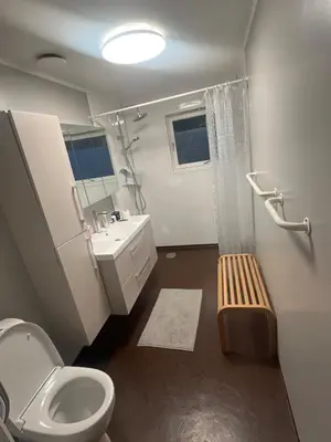 a bathroom with a toilet and a sink at 4 bedroom room House in Beautiful Strandebarm in Kvam