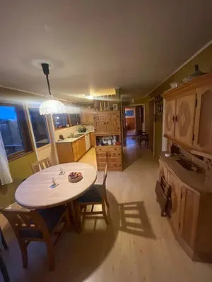 a kitchen and dining room with a table and chairs at 4 bedroom room House in Beautiful Strandebarm in Kvam