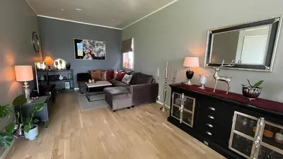 a living room with a couch and a mirror at Strandhus i idylliske omgivelser in Batnfjordsøra