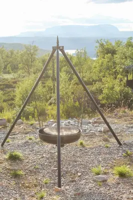 a metal swing in the middle of a field at Charming Log Cabin With Modern Luxury in Dagali