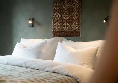 a bed with white pillows in a bedroom at Sov Lodge in Vågåmo