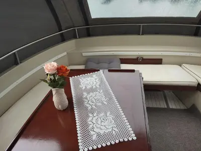 a table in a small boat with a vase of flowers at Flamingo in Vikedal