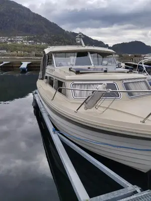 a boat is docked at a dock in the water at Flamingo in Vikedal