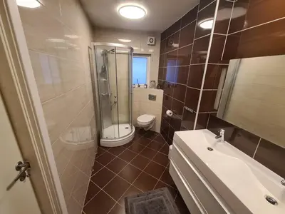 a bathroom with a shower and a toilet and a sink at 6 Bedroom House in Ålesund