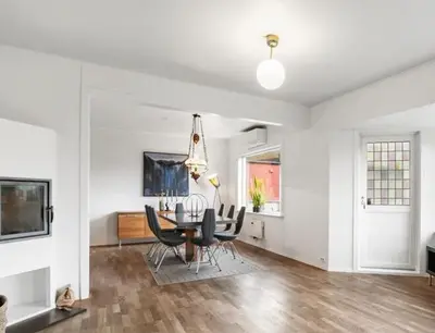 a dining room with a table and chairs at 6 Bedroom House in Ålesund