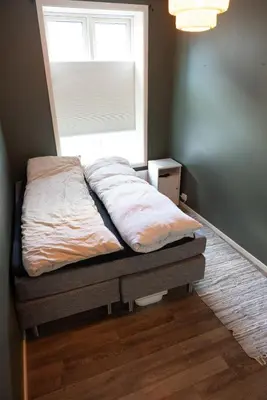 a bed sitting in a bedroom with a window at Big apartment in central Aalesund in Ålesund