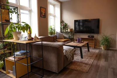 a living room with a couch and a flat screen tv at Big apartment in central Aalesund in Ålesund