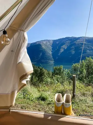 a view of a lake from inside a tent at Glamping Kalhagen in Vangsbygd
