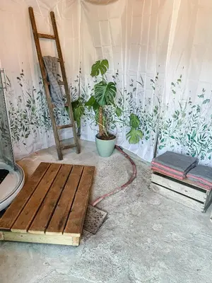 a room with plants on the wall and a bench at Glamping Kalhagen in Vangsbygd