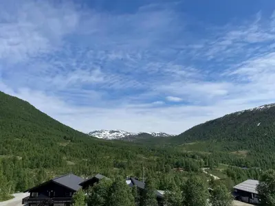 a view of a valley with snow covered mountains at Helgatunlia - Leilighet 1 in Vossevangen