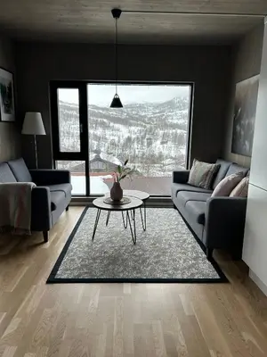 a living room with a couch and a table at Helgatunlia - Leilighet 1 in Vossevangen
