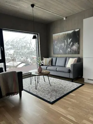 a living room with a couch and a table at Helgatunlia - Leilighet 1 in Vossevangen