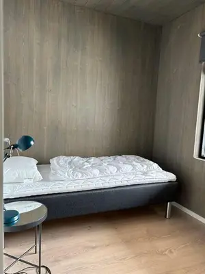 a bed in a room with a table and a bed sidx sidx sidx at Helgatunlia - Leilighet 2 in Vossevangen