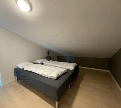 a bedroom with a bed in a room with a ceiling at Helgatunlia - Leilighet 2 in Vossevangen