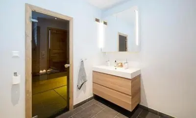 a white bathroom with a sink and a shower at Modern Mountain Cabin With Views At Filefjell in Tyinkrysset