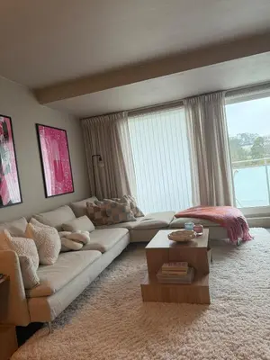 a living room with a couch and a table at Sentral leilighet i Åsane in Sørebø